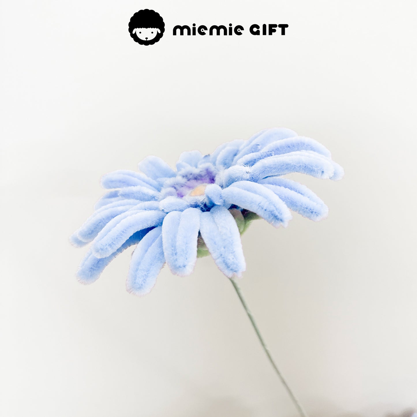 Light blue frangipani flower made with pipe cleaners, featuring soft pastel tones for a delicate and elegant aesthetic.