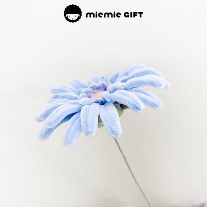 Light blue frangipani flower made with pipe cleaners, featuring soft pastel tones for a delicate and elegant aesthetic.