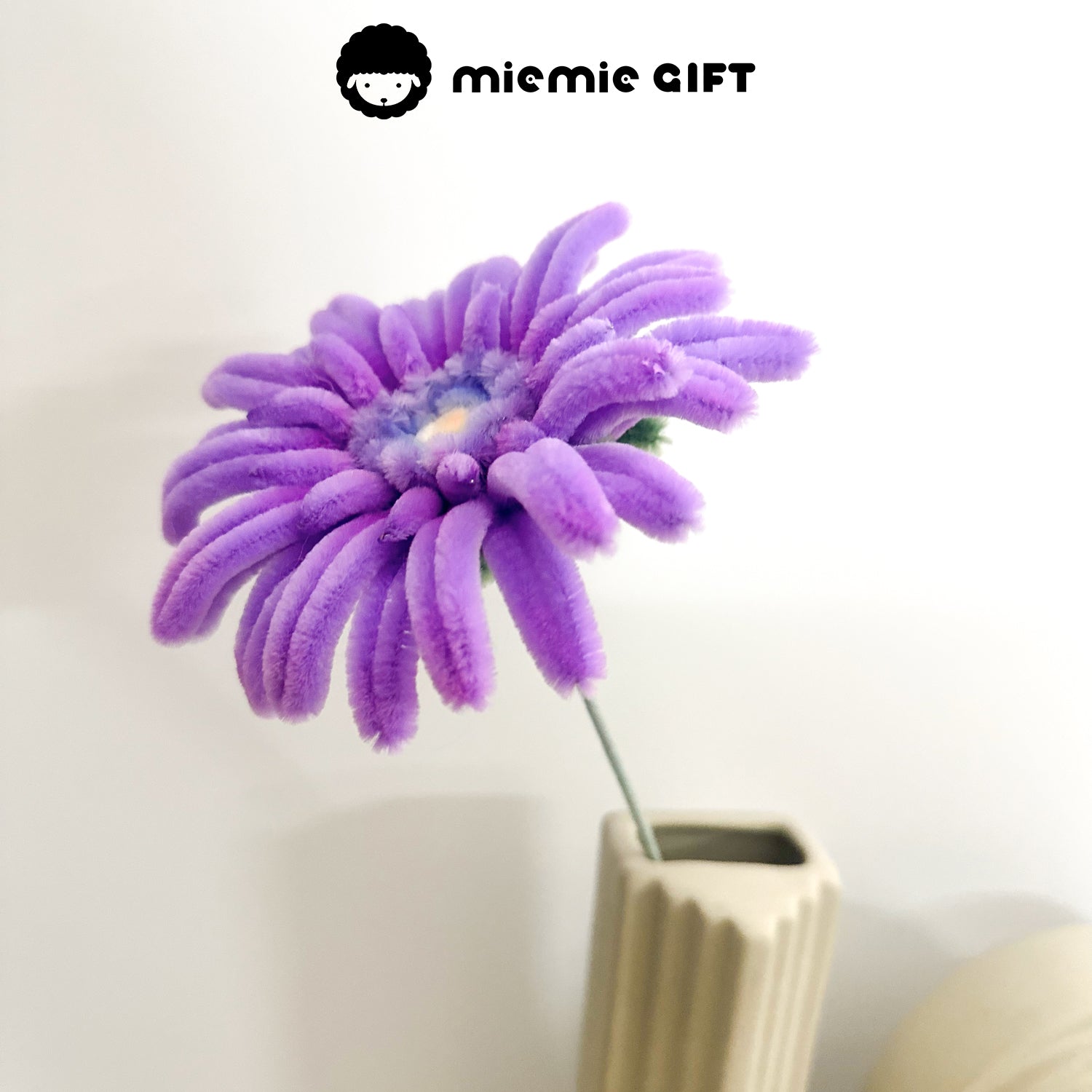 Elegant purple frangipani flower made from pipe cleaners, displayed in a minimalist vase, perfect for floral craft lovers.